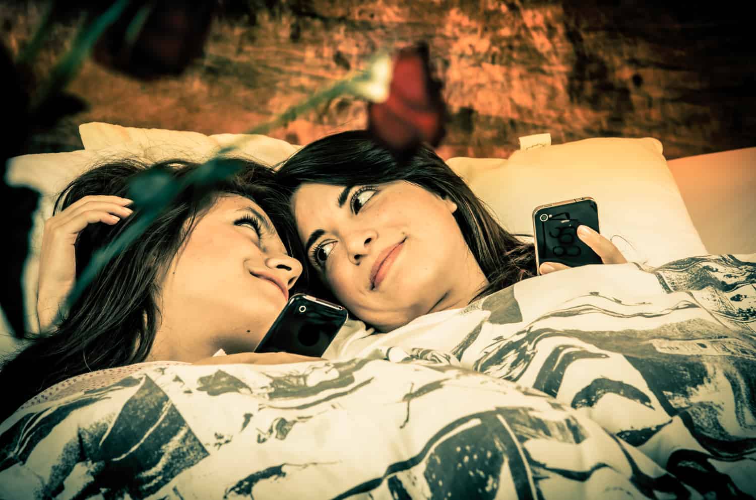 lesbian couple lying in bed